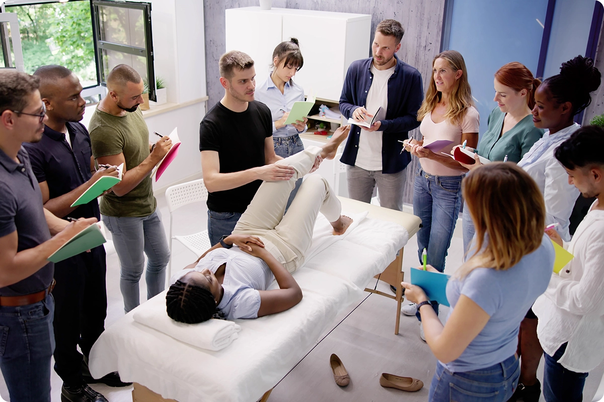 Medical students observing physical therapy session.