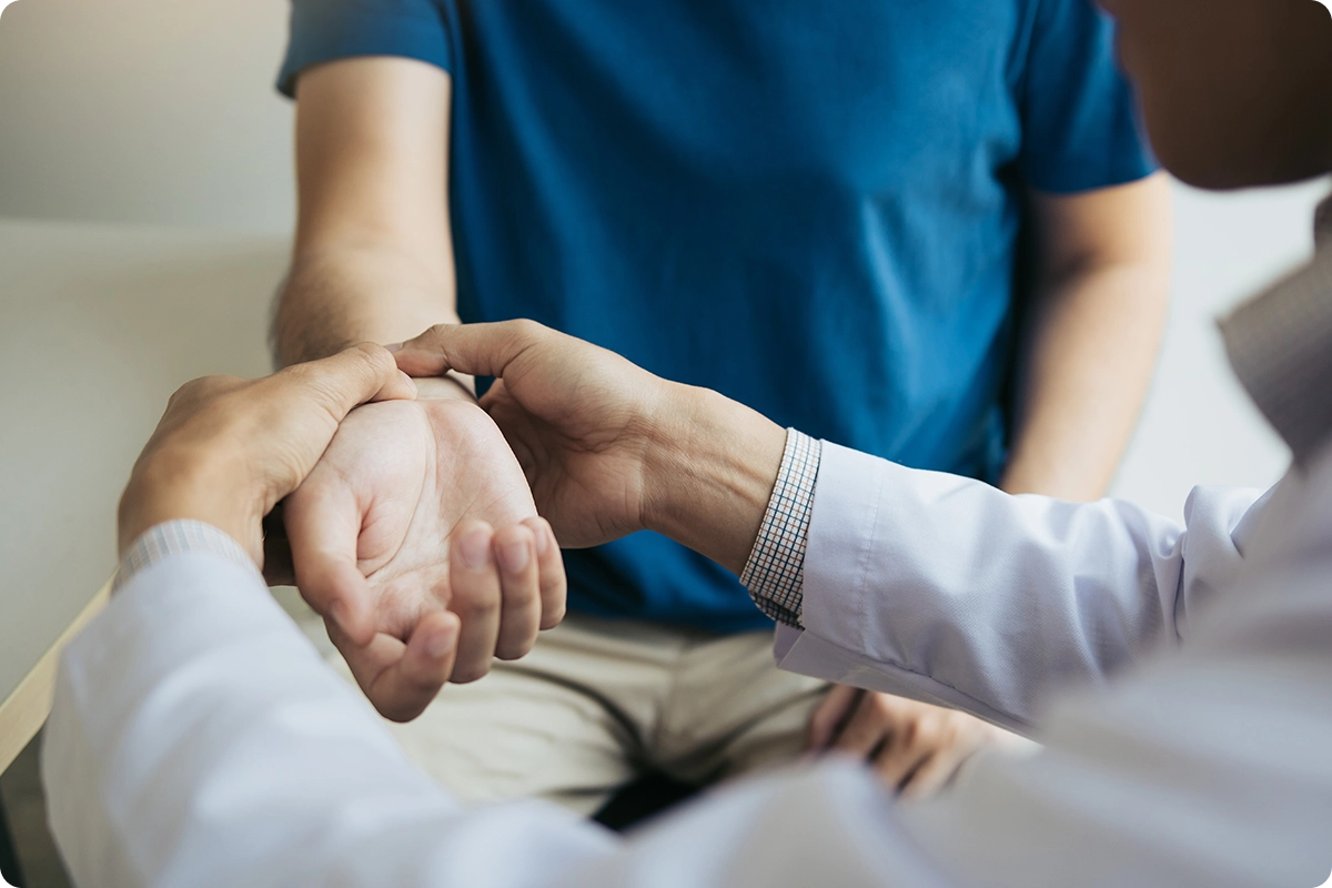 Doctor checking patient's pulse.